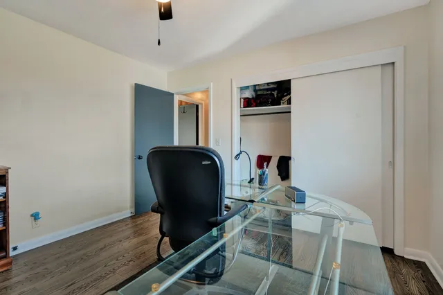 a work room with furniture and wooden floor