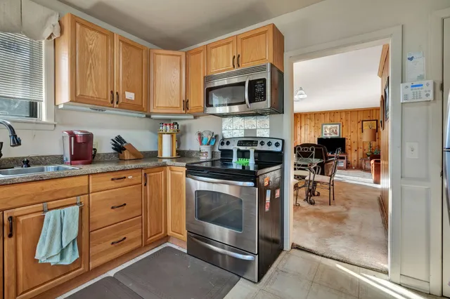 a kitchen with stainless steel appliances granite countertop a stove and a sink