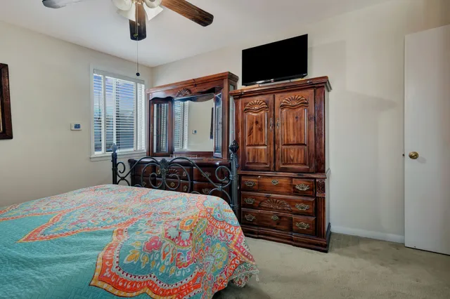 a bedroom with a bed and flat screen tv