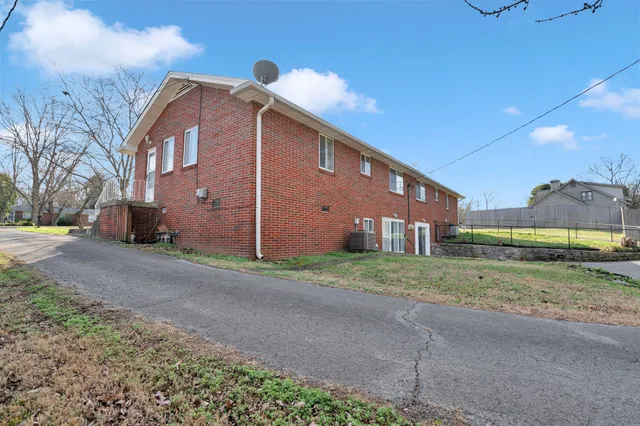 a view of backyard with table and chairs and wooden fence
