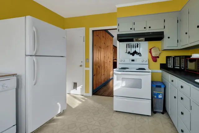 a kitchen with cabinets and appliances