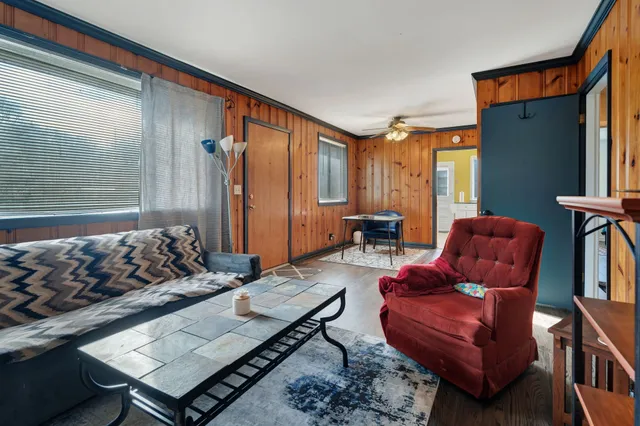a living room with furniture a rug and a window