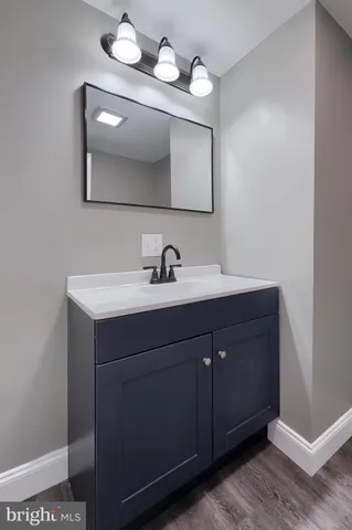 a bathroom with a sink vanity and mirror