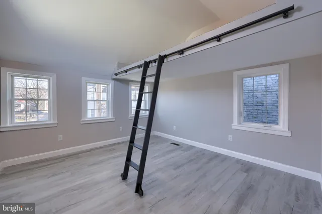 a view of entryway with window and wooden floor