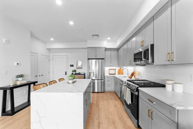 a kitchen that has a lot of cabinets and refrigerator