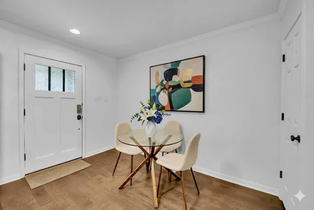 a view of a workspace room with furniture and wooden floor