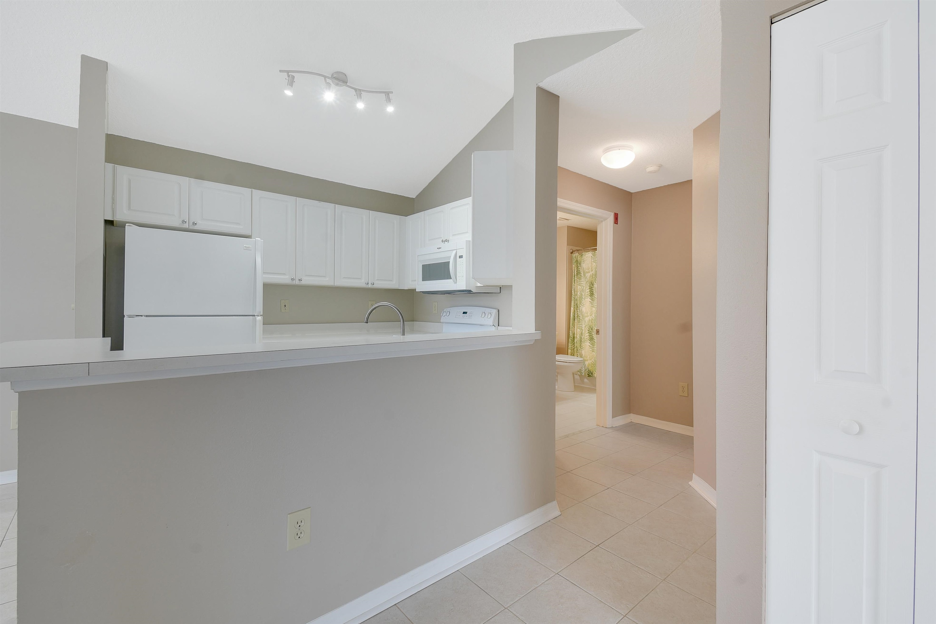24200 Harbour Vista Circle St. Augustine, FL 32080 - Photo 12 of 30 a kitchen with white cabinets and refrigerator