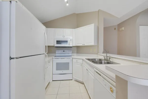 a kitchen with a sink appliances and cabinets
