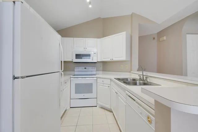 a kitchen with a sink appliances and cabinets