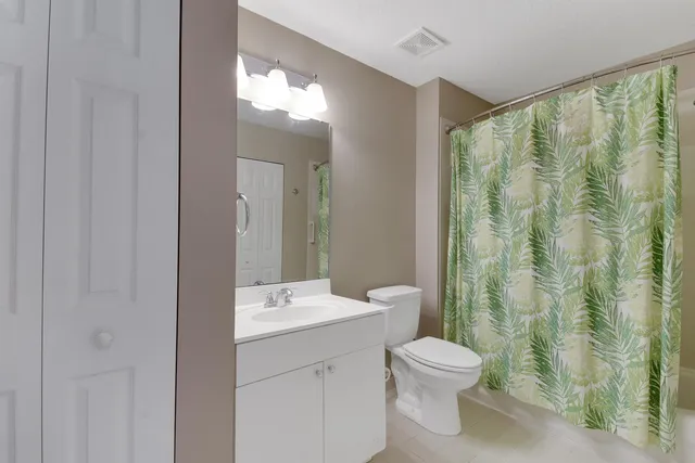 a bathroom with a toilet a sink and a mirror