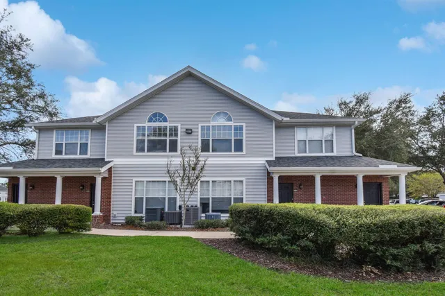 a front view of a house with a yard table and chairs