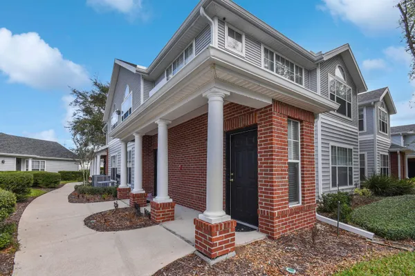 a view of a patio with couches and potted plants