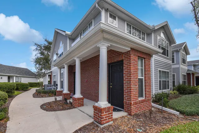 a view of a patio with couches and potted plants