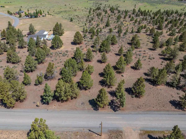 an aerial view of a houses with a yard