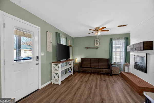 a living room with furniture and a flat screen tv