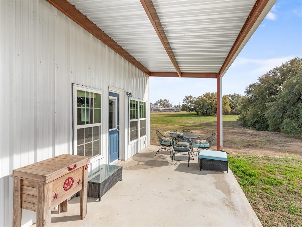 351 County Road 2601 Meridian, TX 76665 - Photo 16 of 40 a view of a patio with a table chairs and a backyard