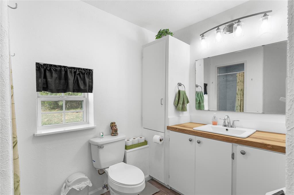 351 County Road 2601 Meridian, TX 76665 - Photo 32 of 40 a bathroom with a sink a toilet and shower