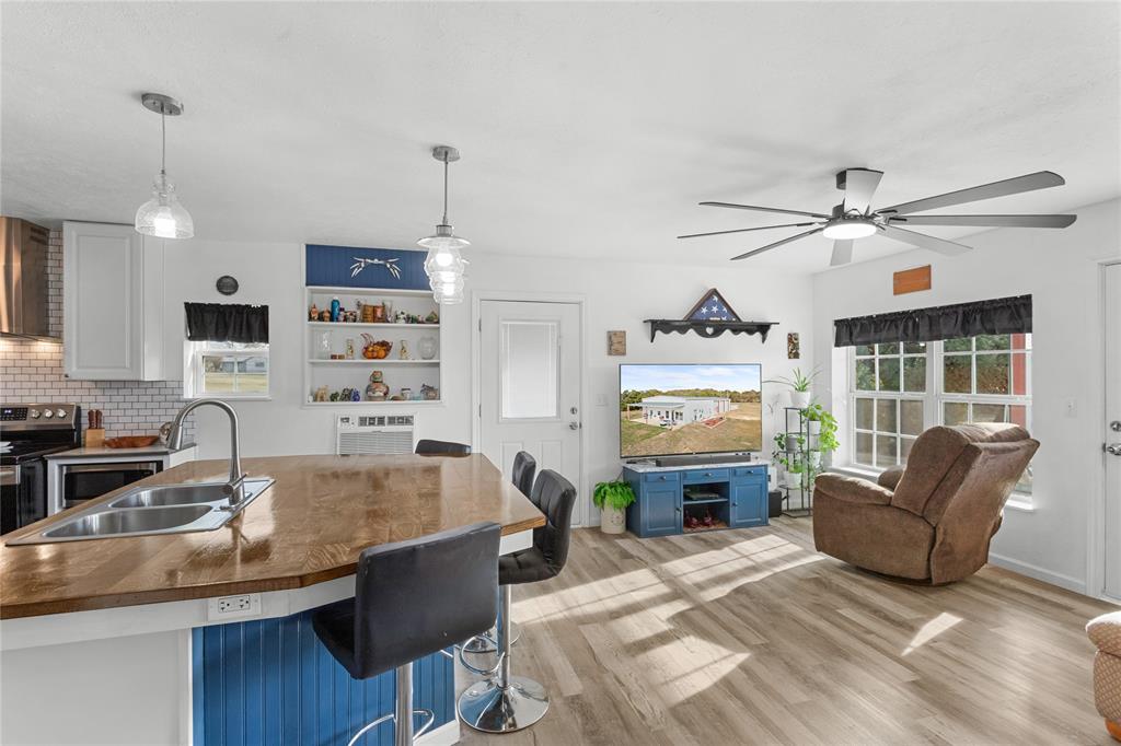 351 County Road 2601 Meridian, TX 76665 - Photo 38 of 40 a living room with furniture a fireplace and a chandelier