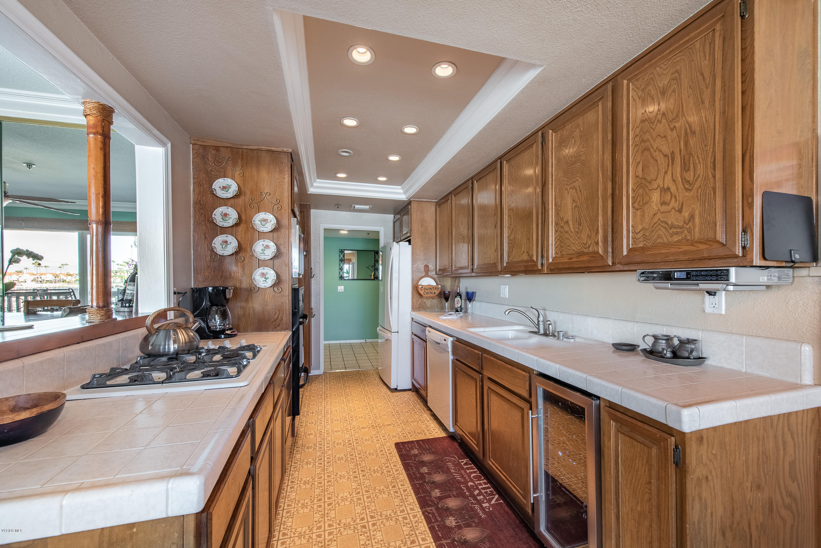 2872 Coast Circle, Unit 203 Huntington Beach, CA 92649 - Photo 15 of 42 a kitchen with a sink stove and cabinets