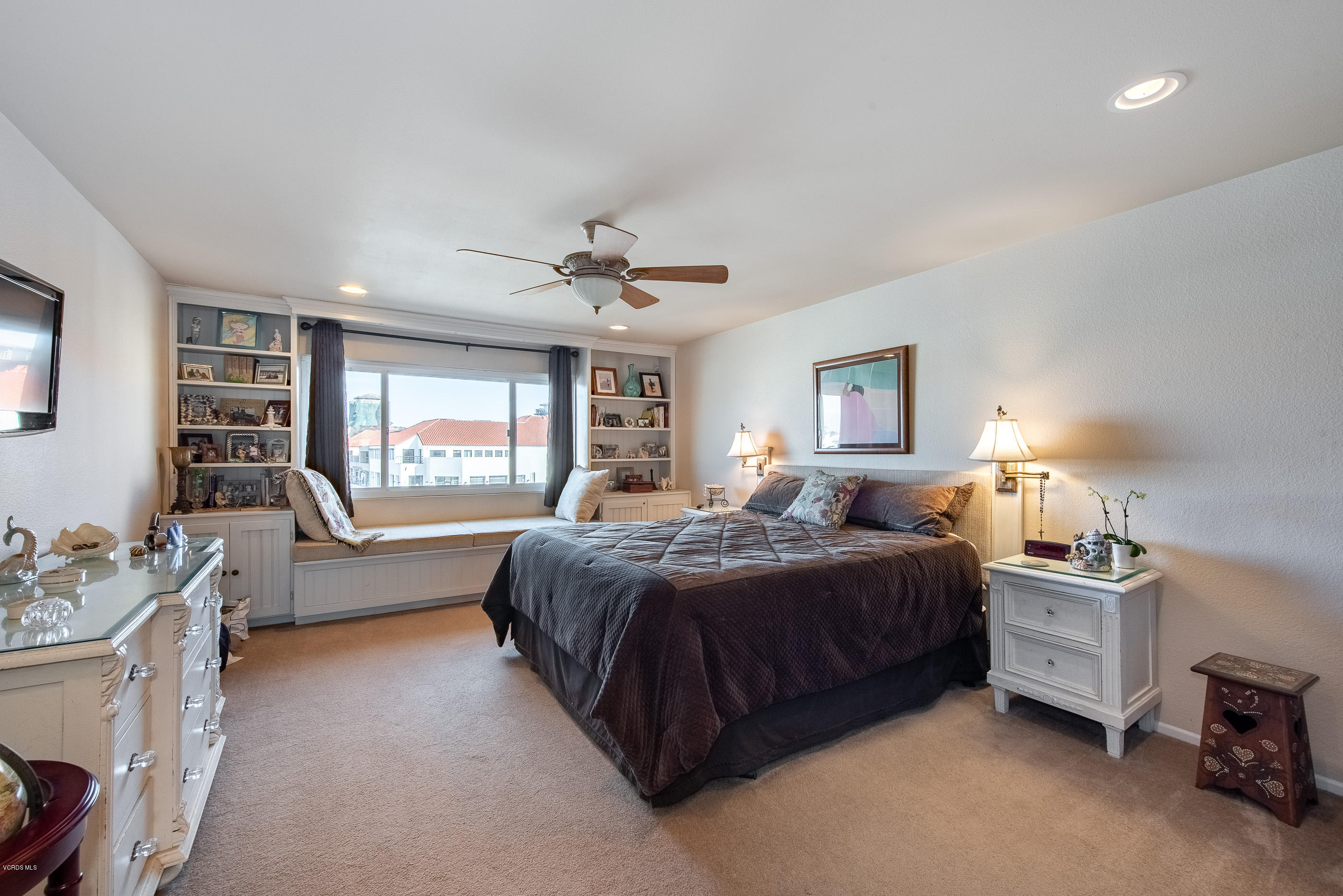 2872 Coast Circle, Unit 203 Huntington Beach, CA 92649 - Photo 25 of 42 a spacious bedroom with a bed a table and dresser