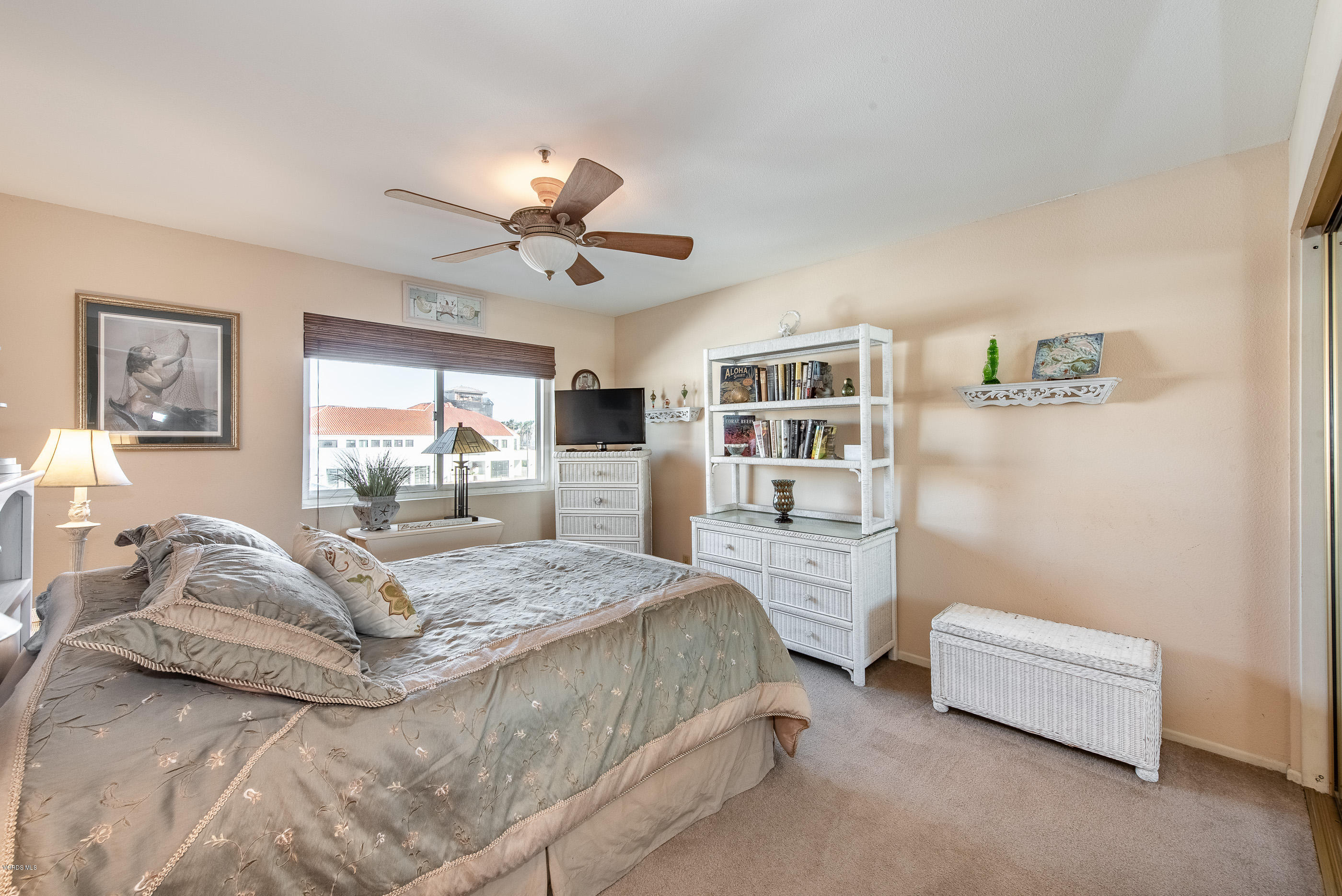 2872 Coast Circle, Unit 203 Huntington Beach, CA 92649 - Photo 28 of 42 a spacious bedroom with a bed couch and a window
