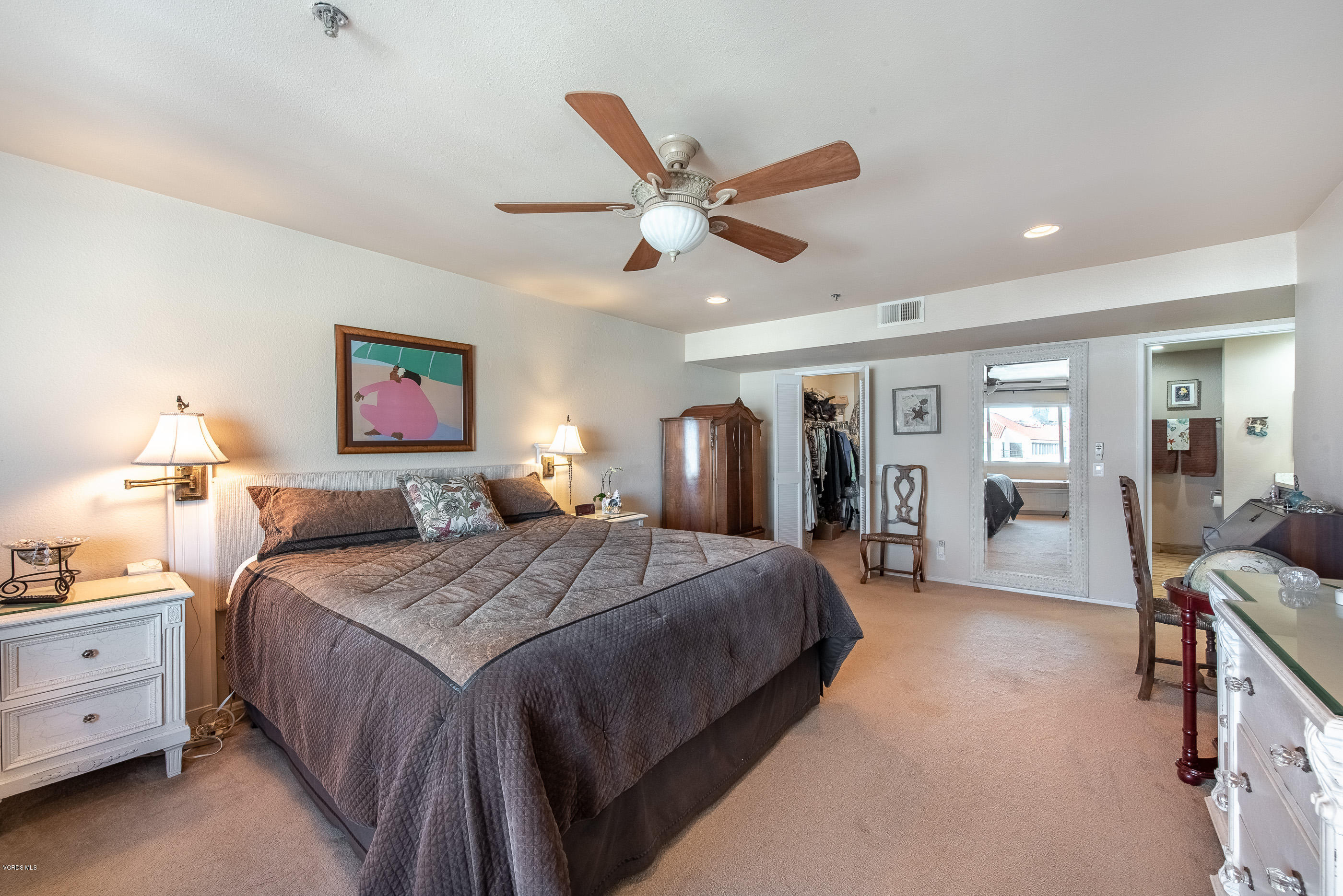 2872 Coast Circle, Unit 203 Huntington Beach, CA 92649 - Photo 4 of 42 a bedroom with a bed and a chandelier