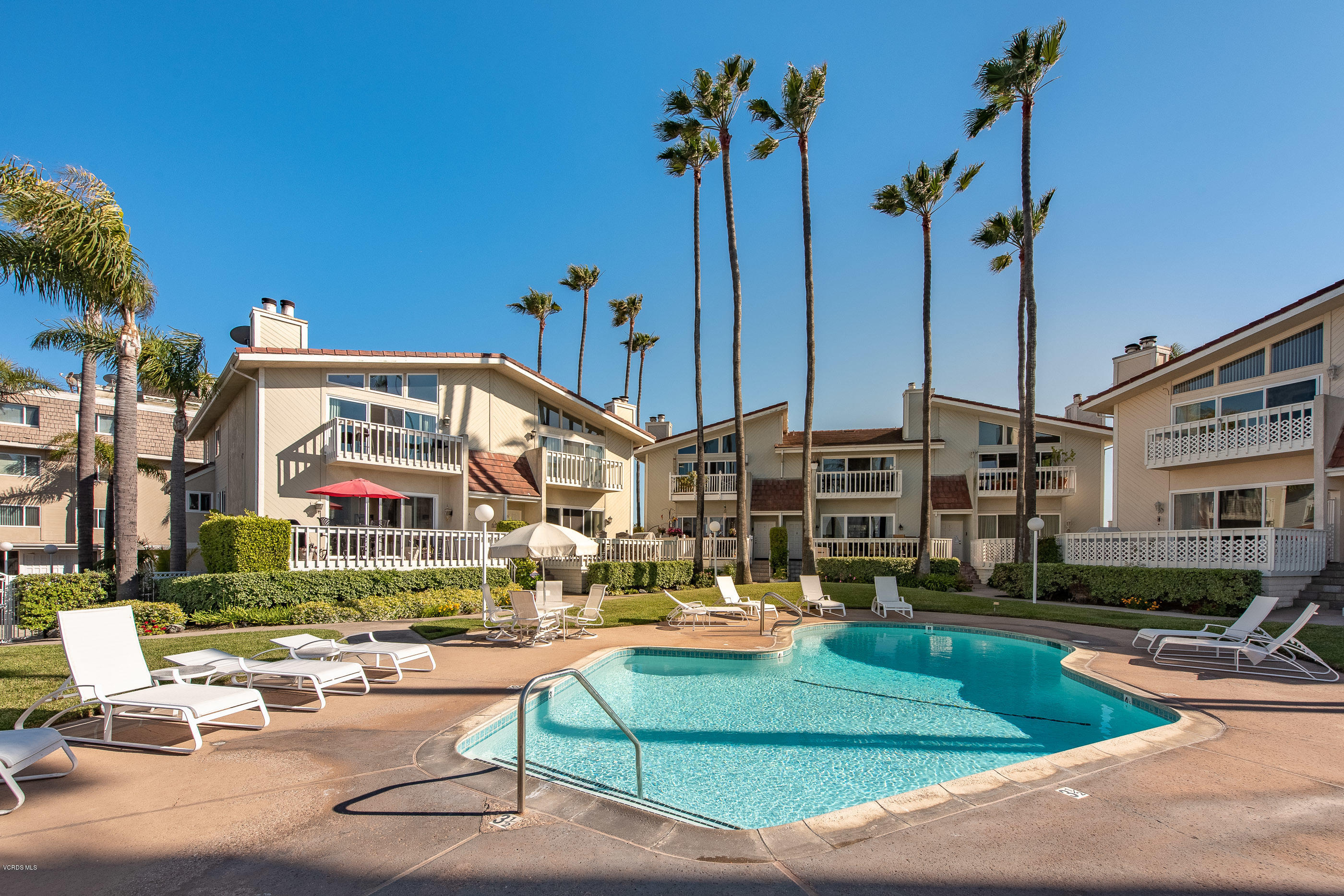 2872 Coast Circle, Unit 203 Huntington Beach, CA 92649 - Photo 32 of 42 a view of a building with a swimming pool