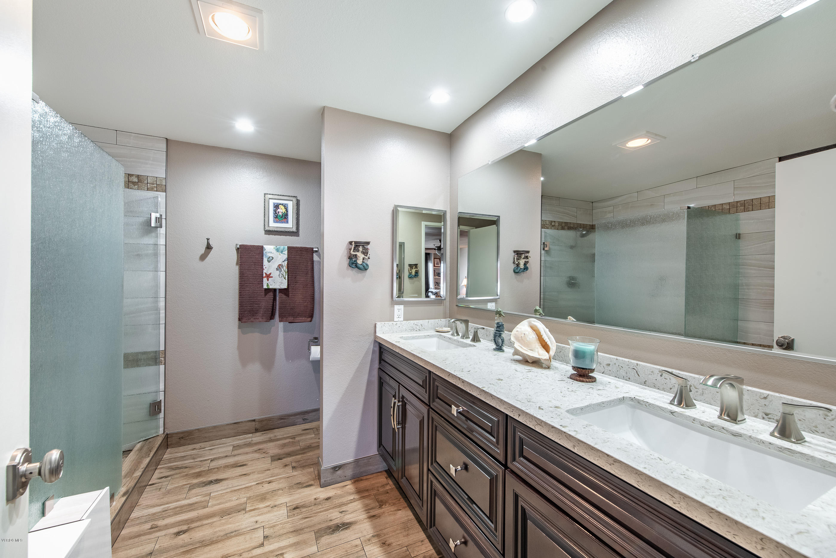 2872 Coast Circle, Unit 203 Huntington Beach, CA 92649 - Photo 5 of 42 a spacious bathroom with a double vanity sink shower and a mirror