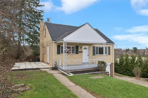 a house that has a big yard and large trees