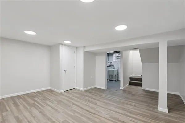an empty room with a empty space and windows