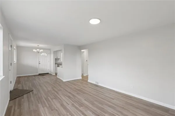 a view of an empty room and wooden floor