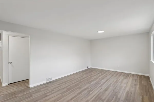 a view of room with wooden floor