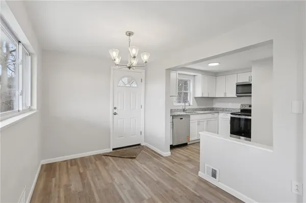 a view of a kitchen with electric appliances
