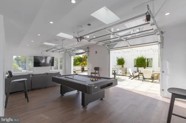 a living room with patio furniture and a large window
