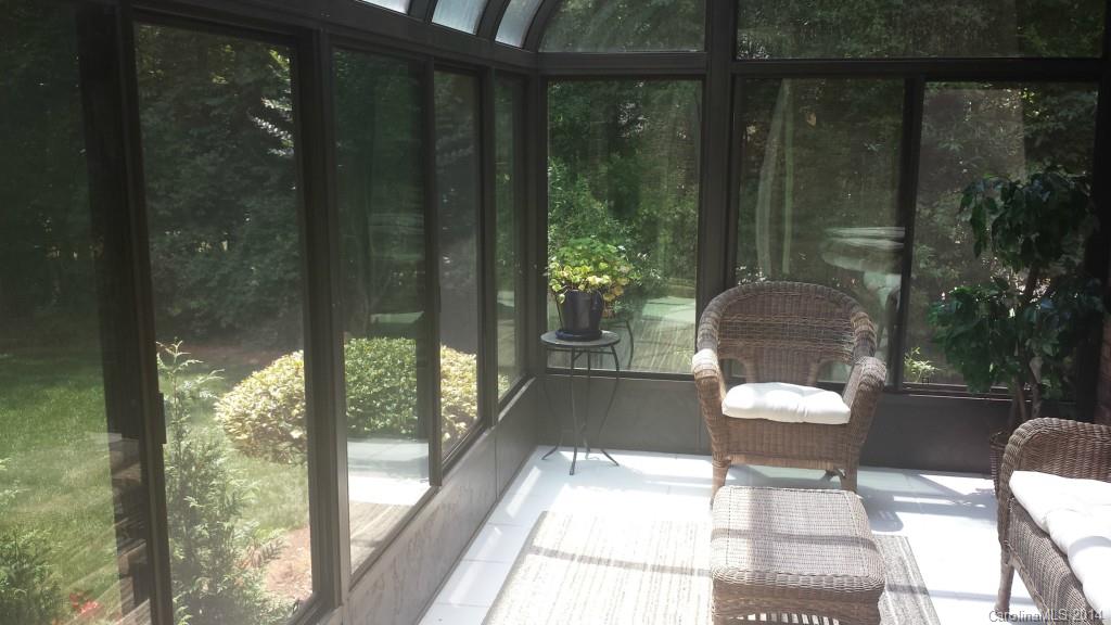 5465 Deer Run Court Davidson, NC 28036 - Photo 13 of 15 a view of a balcony with chair and wooden floor
