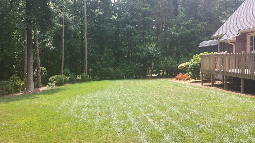 5465 Deer Run Court Davidson, NC 28036 - Photo 15 of 15 a swimming pool with outdoor seating and yard