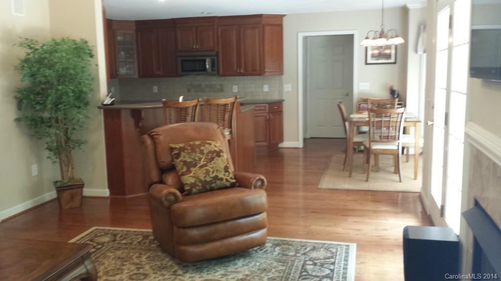 5465 Deer Run Court Davidson, NC 28036 - Photo 3 of 15 a living room with stainless steel appliances furniture a rug a rug and a window