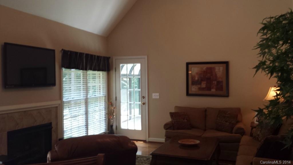5465 Deer Run Court Davidson, NC 28036 - Photo 5 of 15 a living room with furniture tv and a fireplace