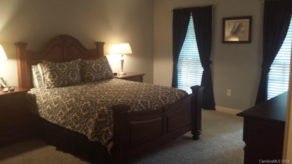 5465 Deer Run Court Davidson, NC 28036 - Photo 9 of 15 a bed sitting in a bedroom next to a window