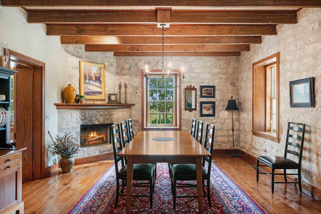 6754 North Grape Creek Road Fredericksburg, TX 78624 - Photo 12 of 47 a view of a dining room with furniture window and wooden floor
