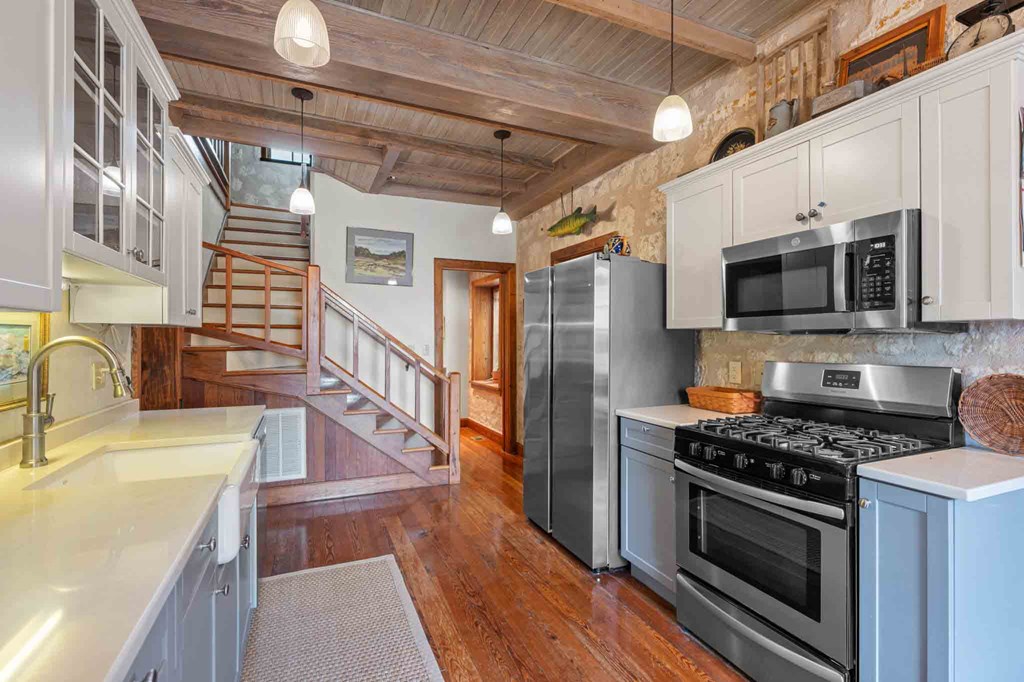 6754 North Grape Creek Road Fredericksburg, TX 78624 - Photo 19 of 47 a kitchen with stainless steel appliances a stove a sink and a microwave