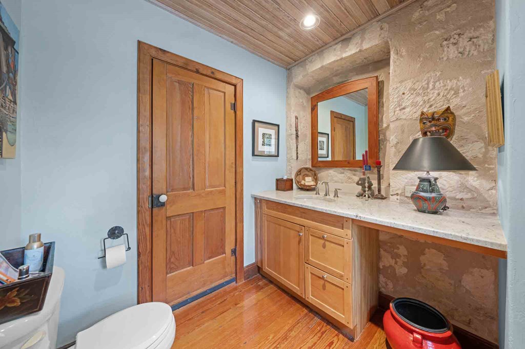 6754 North Grape Creek Road Fredericksburg, TX 78624 - Photo 21 of 47 a bathroom with a toilet sink and mirror