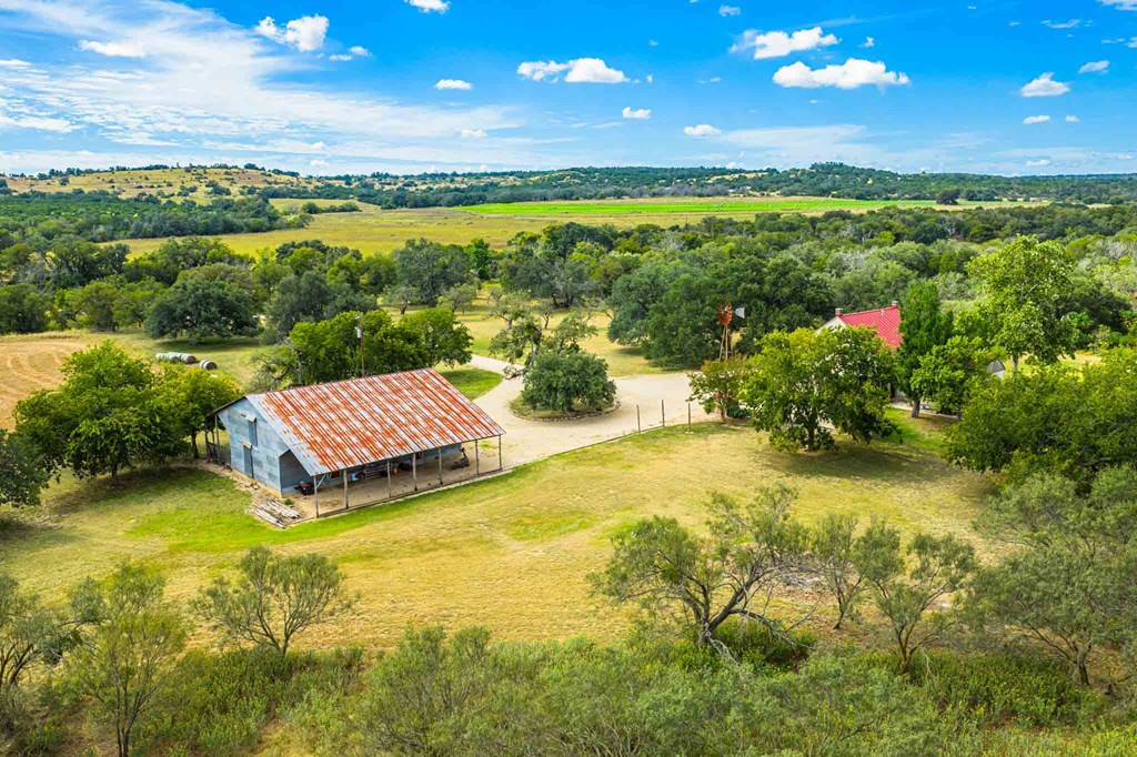 6754 North Grape Creek Road Fredericksburg, TX 78624 - Photo 33 of 47 a view of a lake with a house in the background