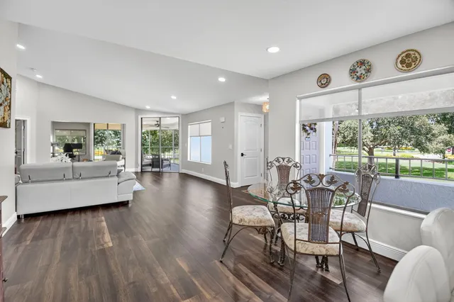 a living room with furniture and large windows