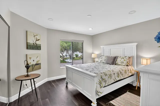 a bedroom with a large bed and a dresser