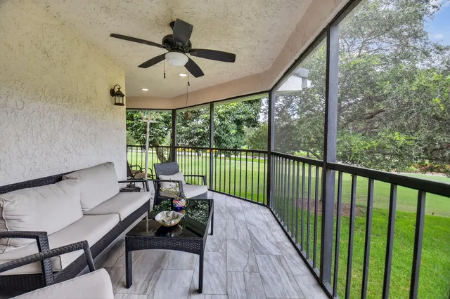 a front view of a house with a yard and potted plants