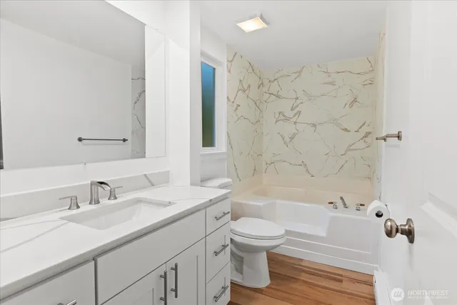 a bathroom with a sink toilet and shower