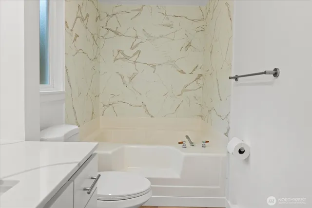 a bathroom with a bathtub and shower