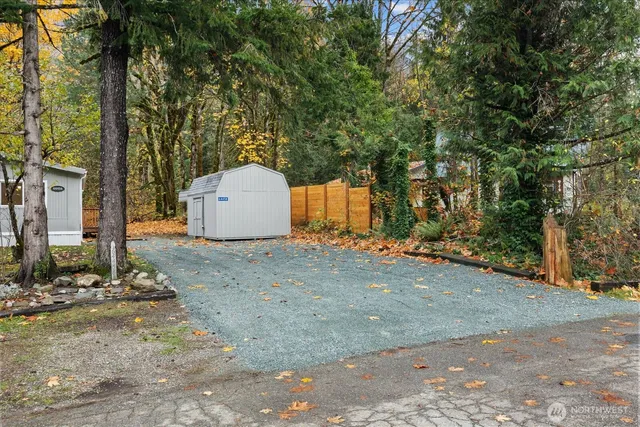 a backyard of a house with garage and outdoor seating