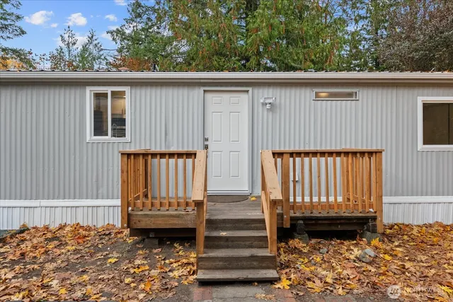 a view of a house with a wooden fence